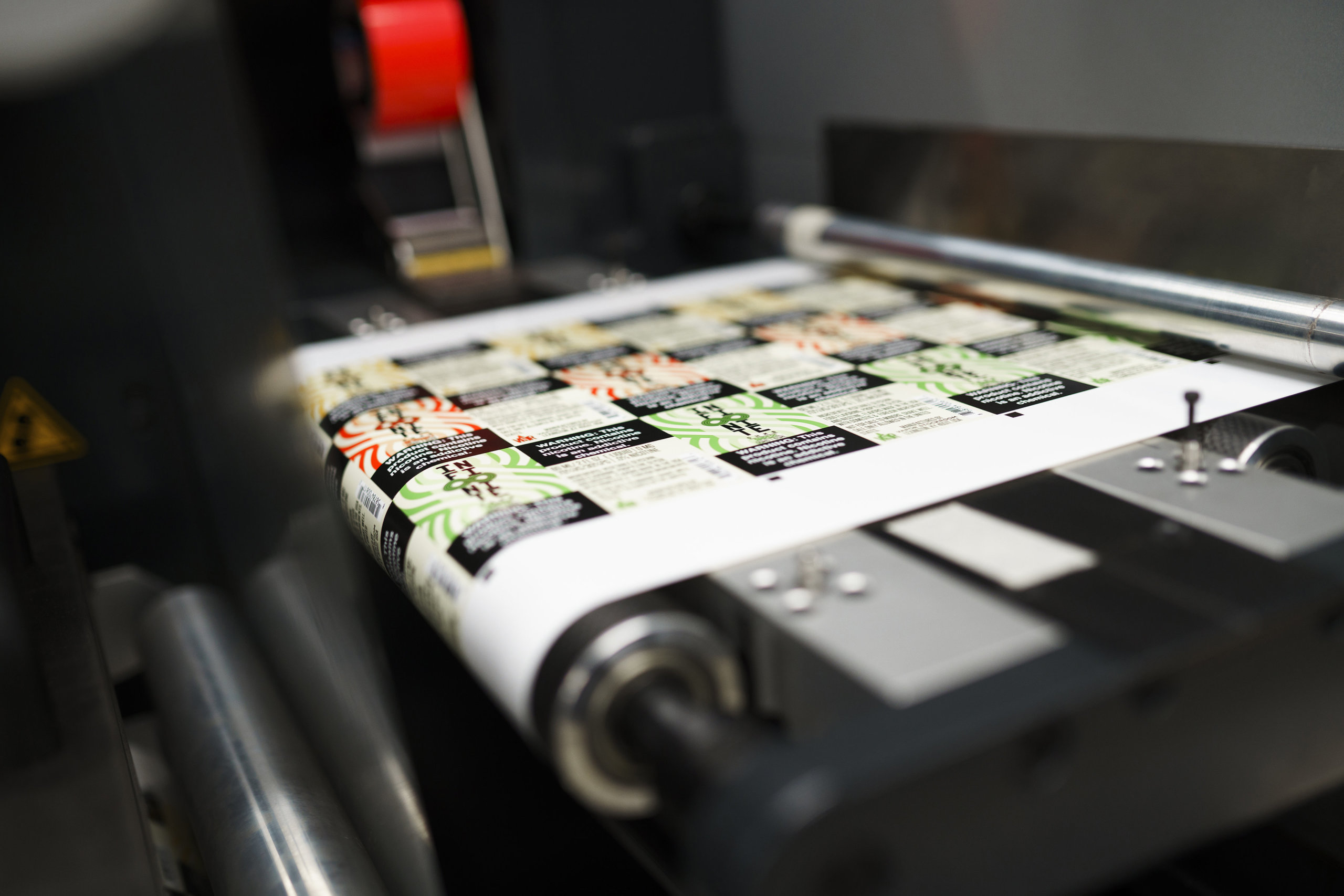 A digital label printer utilizing flexo label printing techniques for finishing.