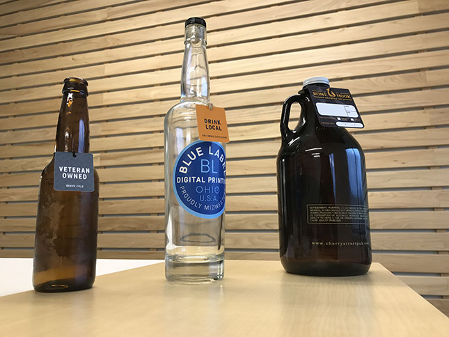 Various sized beer bottles with hang tags.