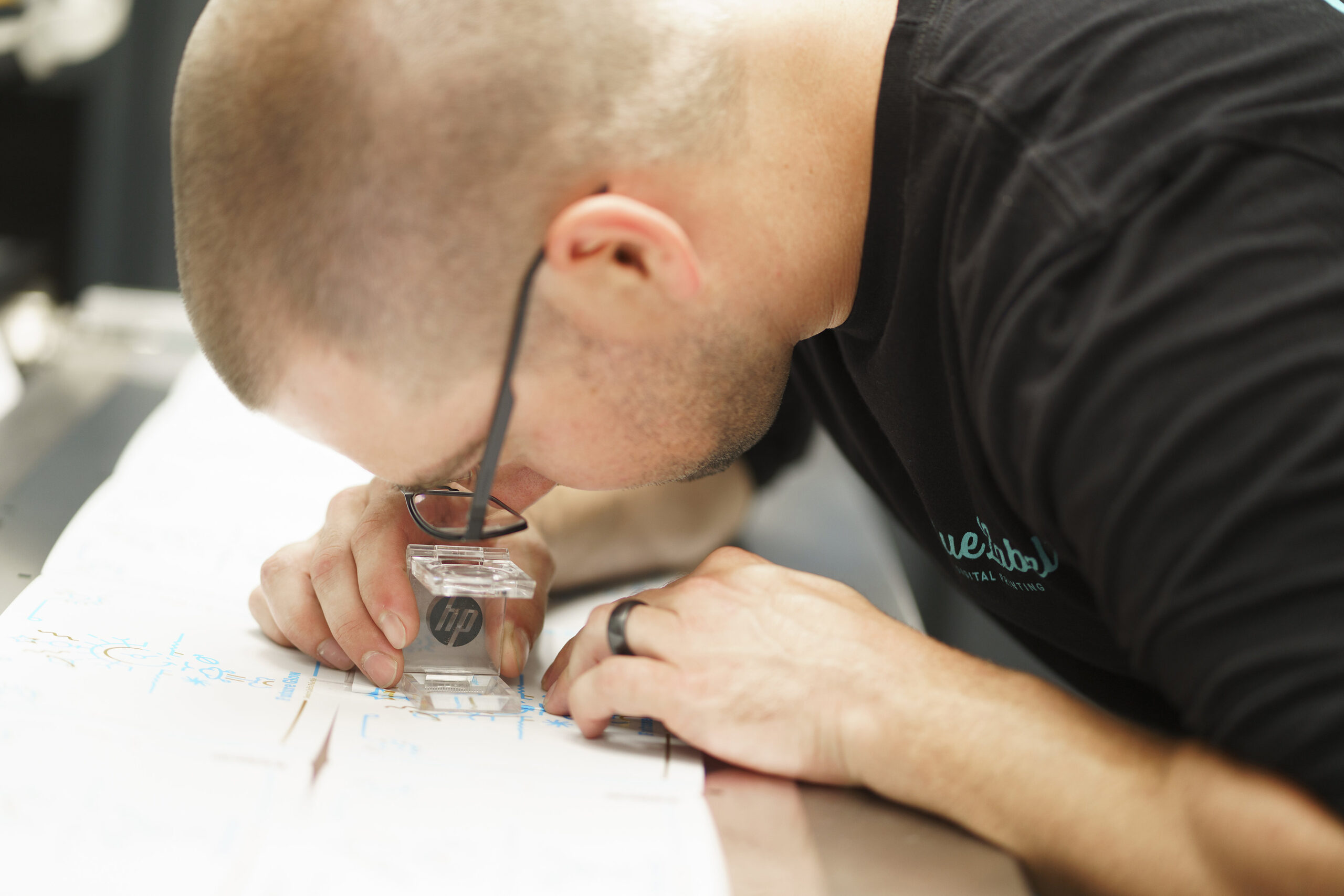 A professional examining labels for essential oils.