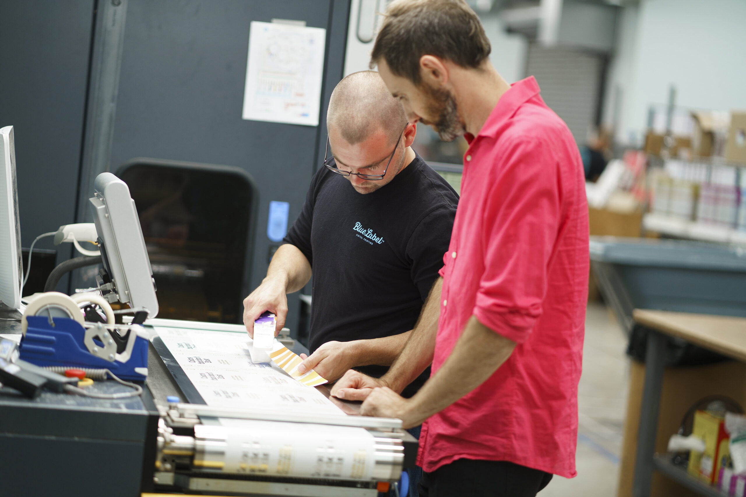 Professionals checking a new run of essential oil bottle labels.