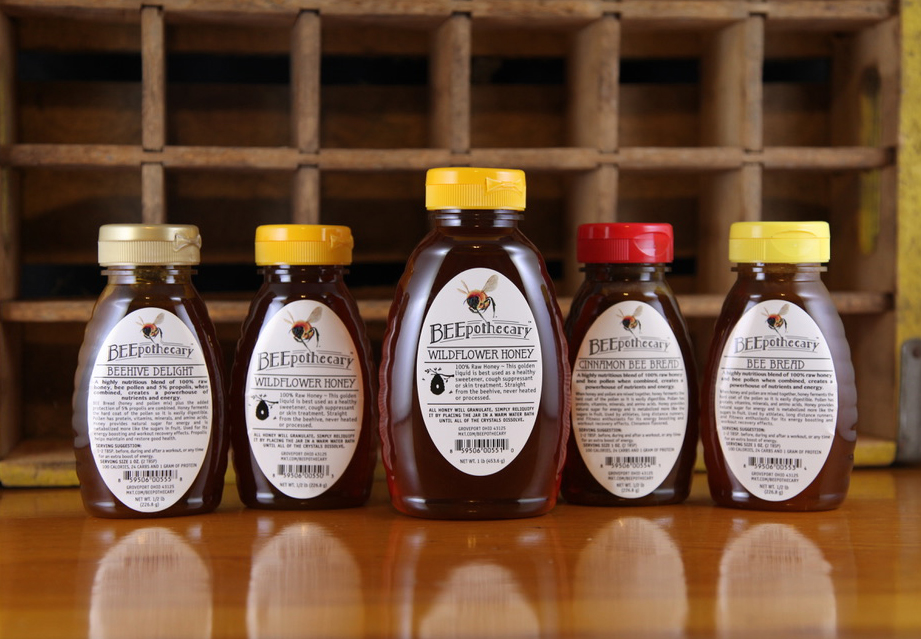 A collection of honey labels on honey jars.