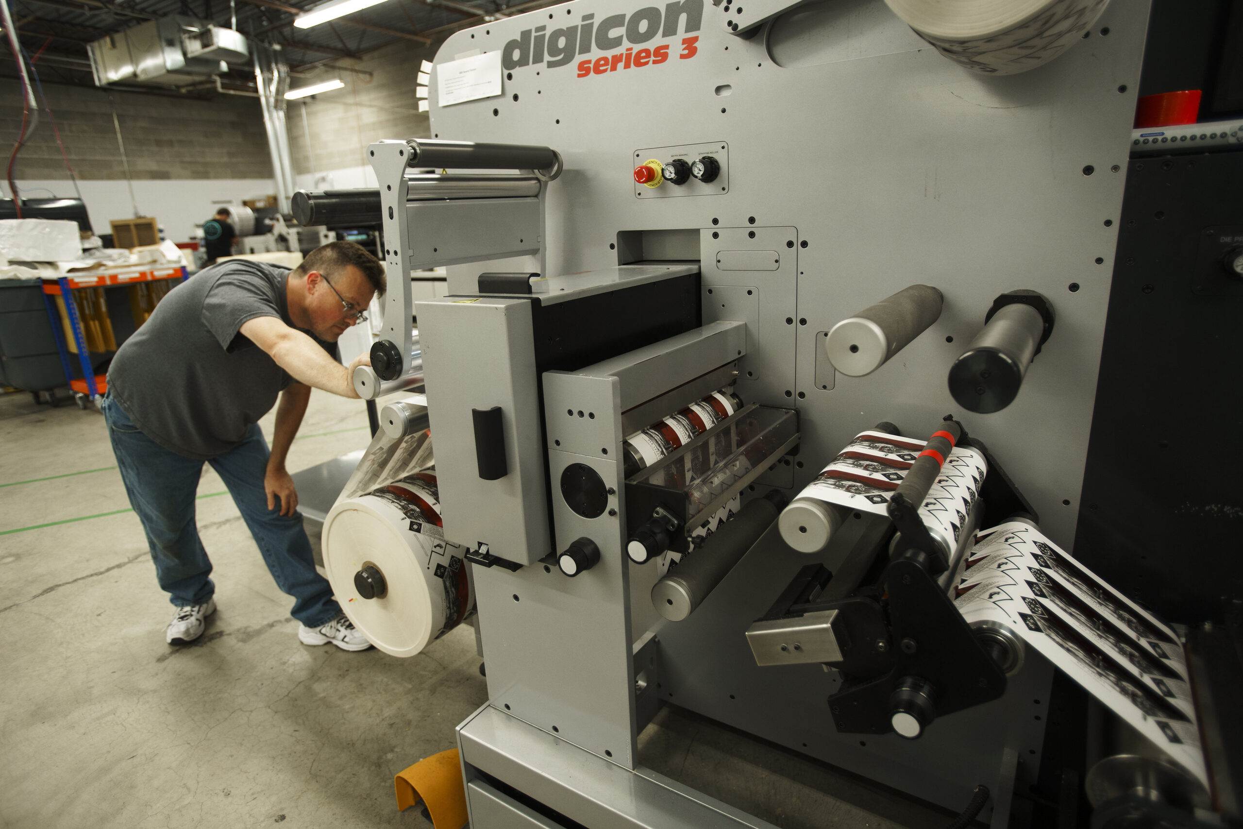 Product labels going through a finishing machine.