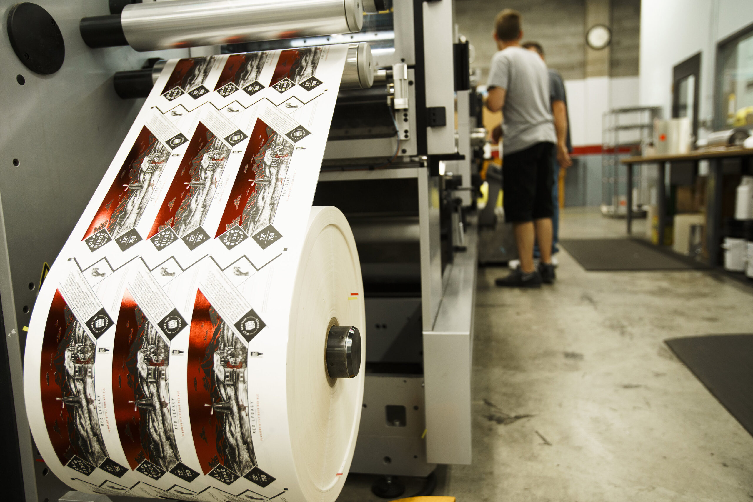 Bottle labels being printed with a protective laminate.