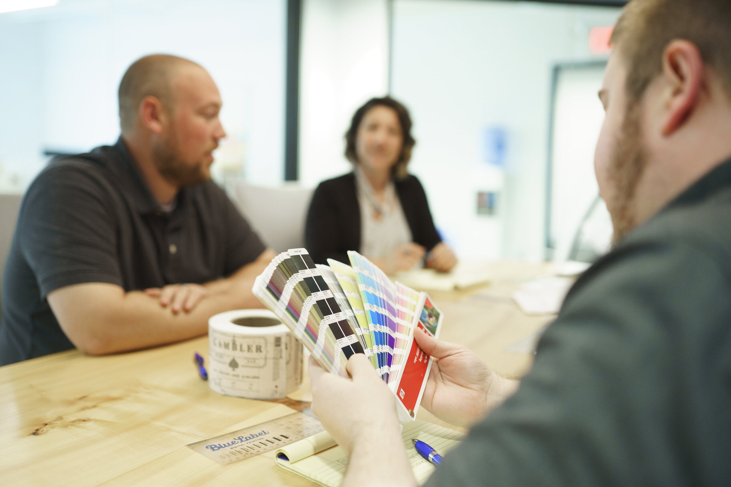 Label printing experts reviewing color options for a product.