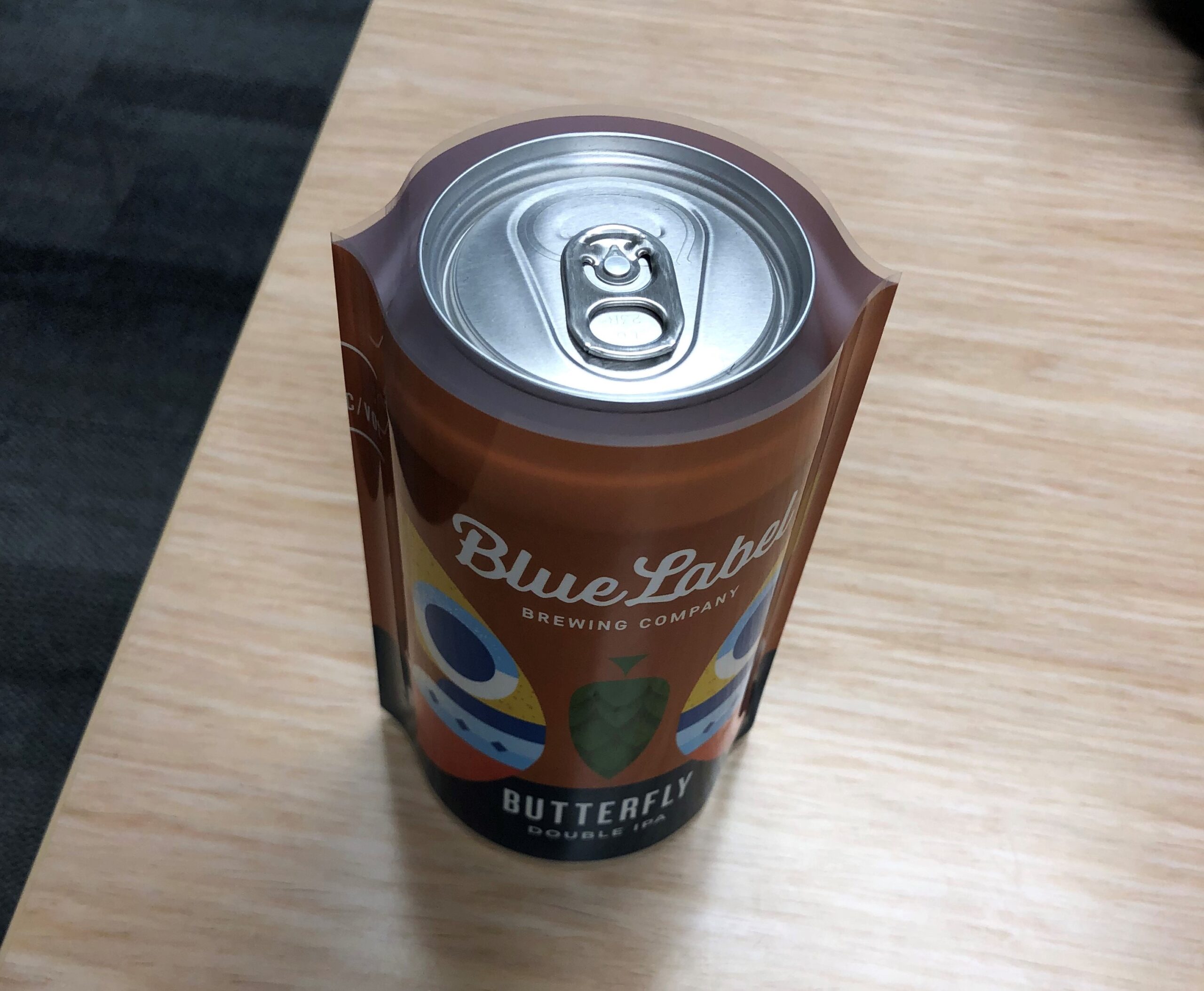 A shrink sleeve slipped over a beer can.