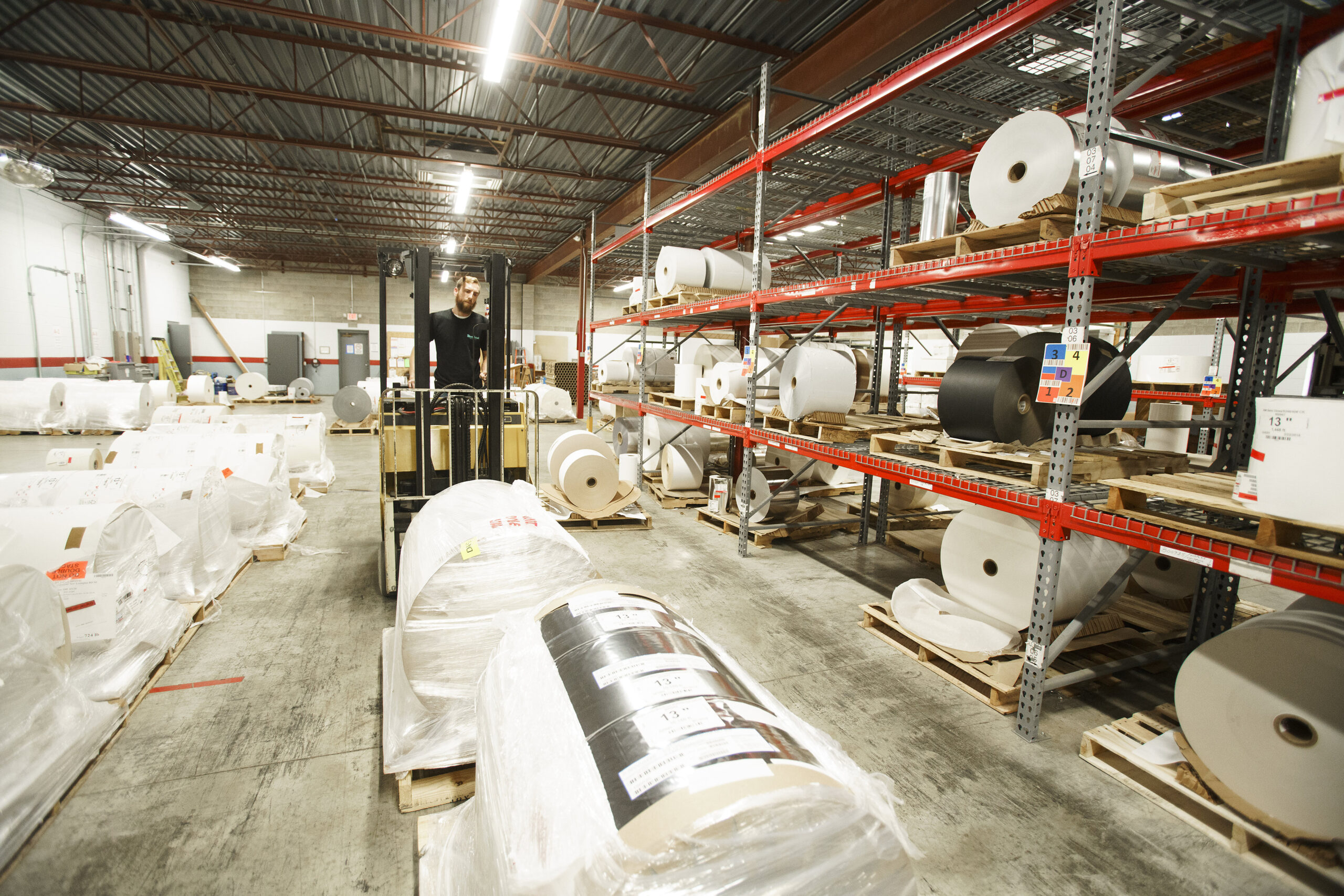 A warehouse with shrink sleeves and other product labels.