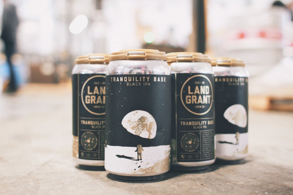 A six-pack of beer with durable product labels sitting on a storage space floor.