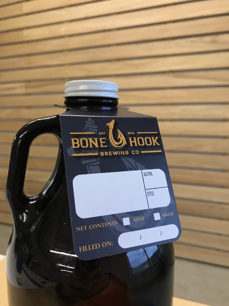 A 64 oz. growler with a hang tag attached.