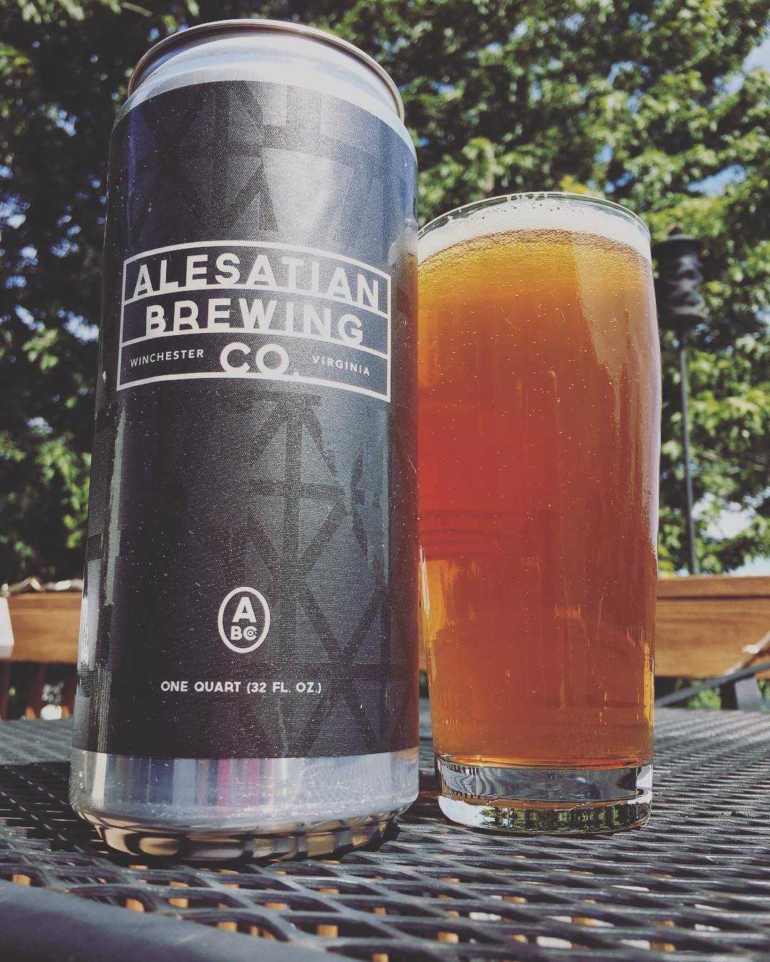 Alesatian Brewing Co. crowler can with custom label design and full beer glass